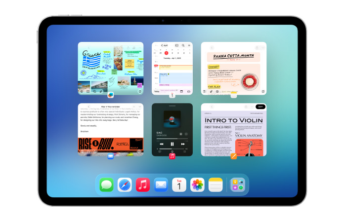 iPad vaaka-asennossa, näytöllä useita appeja, kuten Kalenteri- ja Musiikki-appi, kuudessa samankokoisessa ikkunassa jotka on järjestetty kahteen riviin