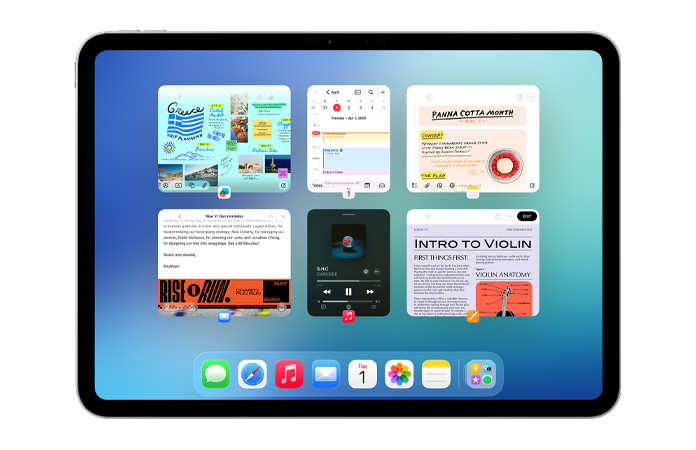iPad vaaka-asennossa, näytöllä avoinna kuusi ikkunaa kahdessa rivissä, mukana Kalenteri-appi, Muistiinpanot-appi, Apple Music ja Safari